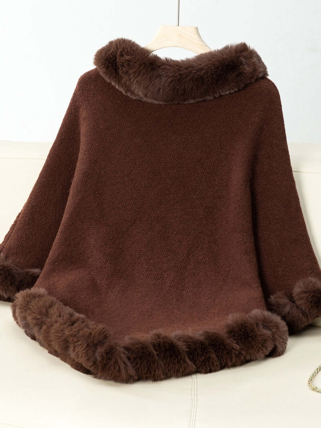 Cozy brown poncho with fuzzy trim, showcasing a stylish back design perfect for chilly days.