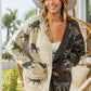 Woman wearing open front long sleeve contrast cardigan with leopard print, styled with a white hat and casual outfit.