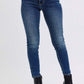 Judy Blue mid-rise waist skinny jeans in dark wash, featuring pockets, styled with chic black heeled boots.