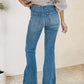 Woman wearing distressed raw hem bootcut jeans with pockets, back view showcasing slightly stretchy denim fabric, casual outfit.