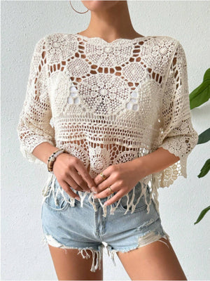 Openwork round neck cover-up in cream, styled with distressed denim shorts for a chic beach look.