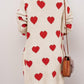 Woman wearing Bella Road Heart Open Front Long Sleeve Cardigan with red hearts, back view showing cozy design and paired with a brown purse.