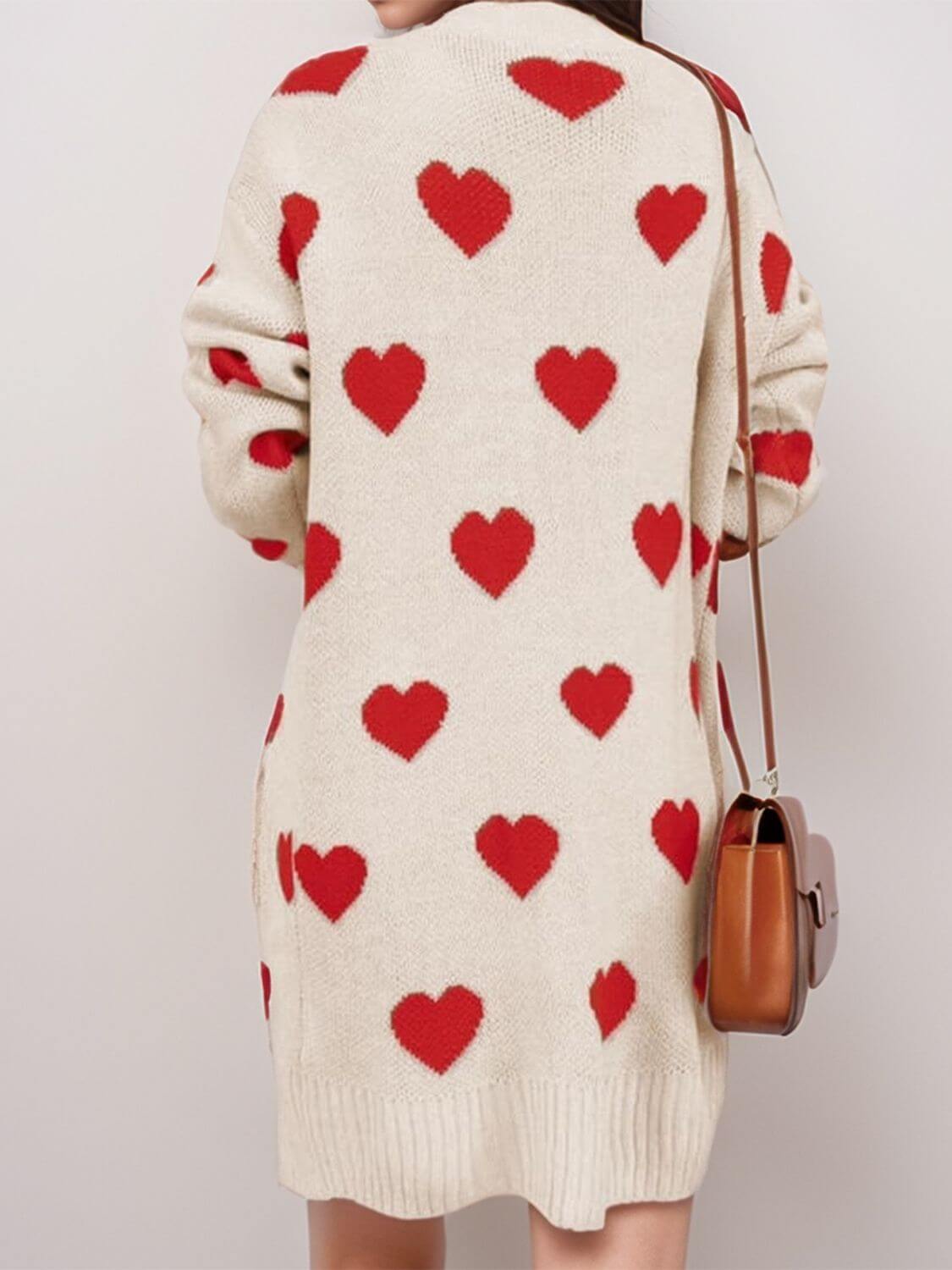 Woman wearing Bella Road Heart Open Front Long Sleeve Cardigan with red hearts, back view showing cozy design and paired with a brown purse.