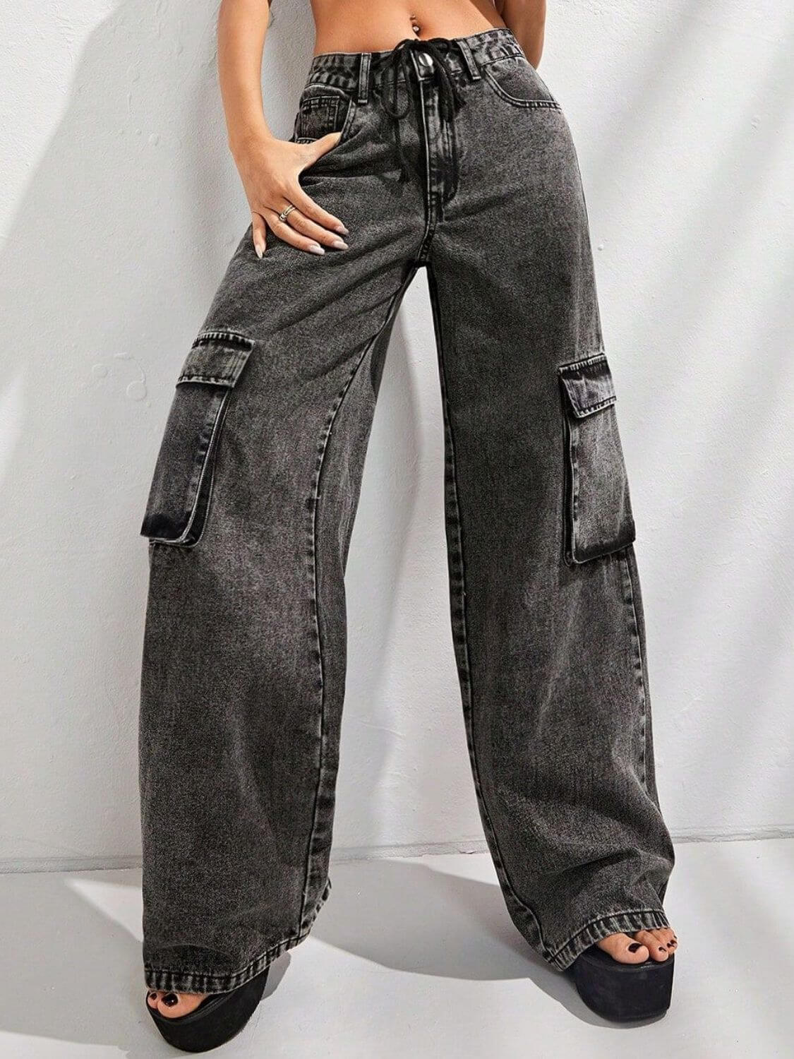 Woman wearing Bella Road wide leg jeans with pockets, showcasing black-washed denim, casual streetwear style.