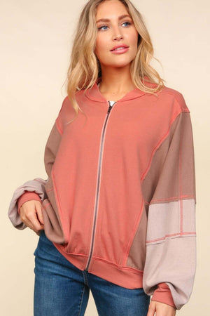 Stylish color block bomber jacket with zip-up front and side pockets, perfect for layering over casual outfits for a trendy look.