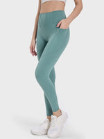 Millennia Pocketed High Waist Active Leggings in teal, perfect for workouts with stylish pockets for convenience.