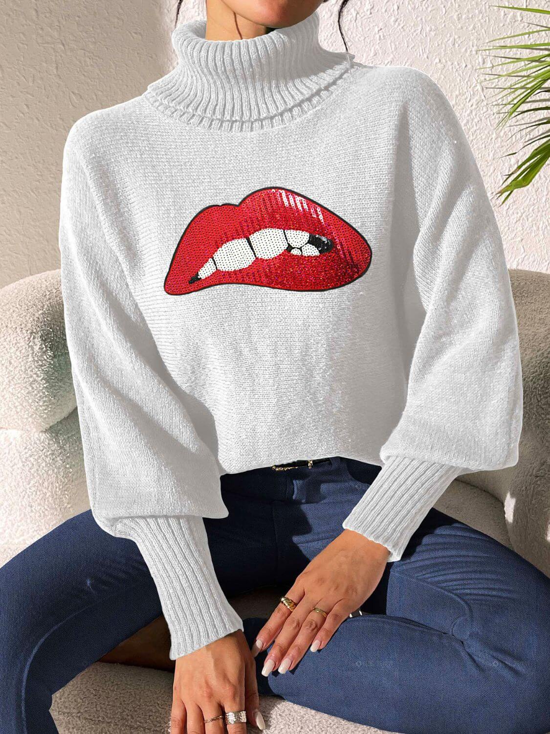 Bella Road Lip Turtleneck Long Sleeve Sweater in white with bold lips graphic, showcasing trendy and quirky style.