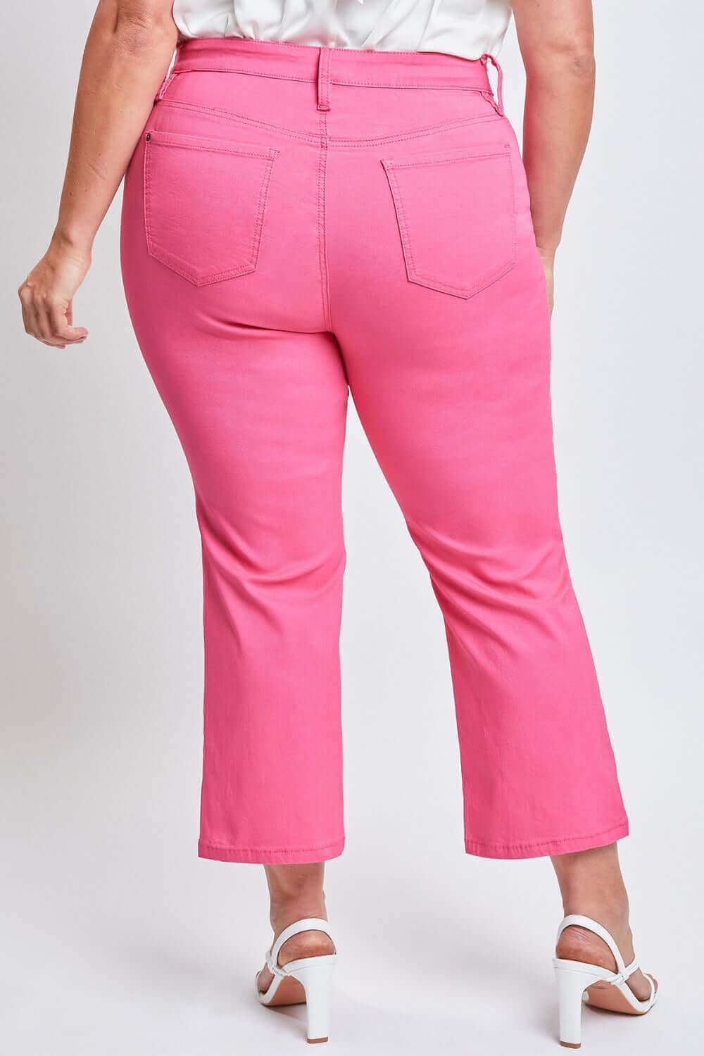 Back view of plus-size model wearing pink Mid-Rise Hyperstretch Cropped Straight Pants by YMI Jeans