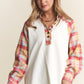 Woman in J.NNA Plaid Contrast Button Down Henley Top with jeans smiling stylishly