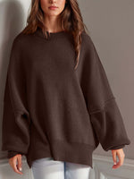 Woman wearing Double Take Side Slit Round Neck Long Sleeve Sweater in dark brown with playful side slit design.