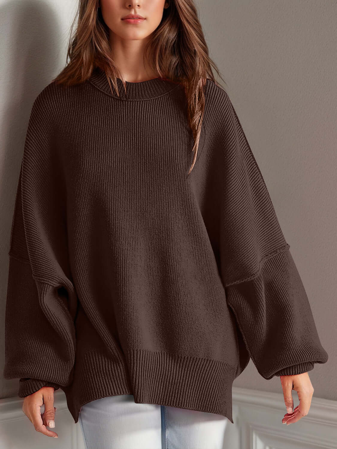 Woman wearing Double Take Side Slit Round Neck Long Sleeve Sweater in dark brown with playful side slit design.