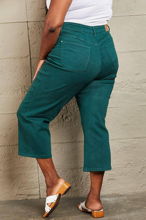 Woman wearing Hailey full size tummy control high waisted cropped wide leg teal Judy Blue jeans with heels