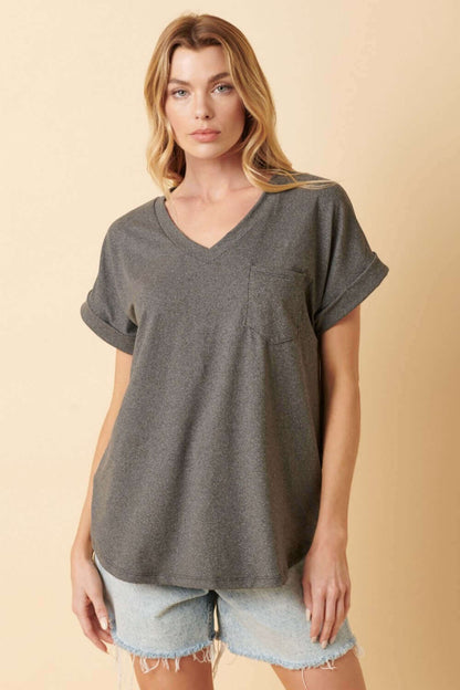 Woman wearing V-Neck Rolled Short Sleeve T-Shirt in dark gray with denim shorts, casual and stylish attire.