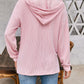 Woman wearing pink drawstring dropped shoulder long sleeve hoodie, shown from the back.