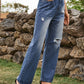 Woman wearing Bella Road Distressed Jeans with stylish pockets in navy, showcasing a casual yet edgy look.