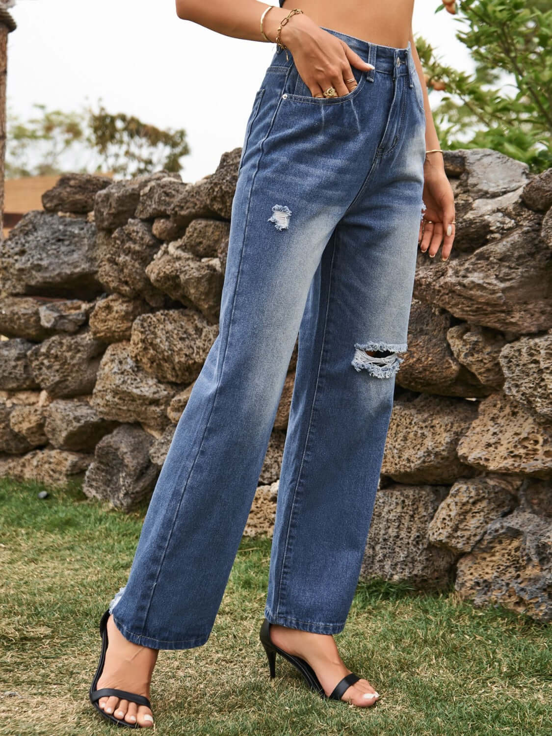 Woman wearing Bella Road Distressed Jeans with stylish pockets in navy, showcasing a casual yet edgy look.