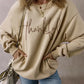 Woman wearing Bella Road Thankful Round Neck Long Sleeve Sweatshirt with jeans and a handbag