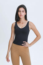 Model wearing a black Millennia V Neck Active Tank, showcasing its flattering fit and sporty style for workouts.