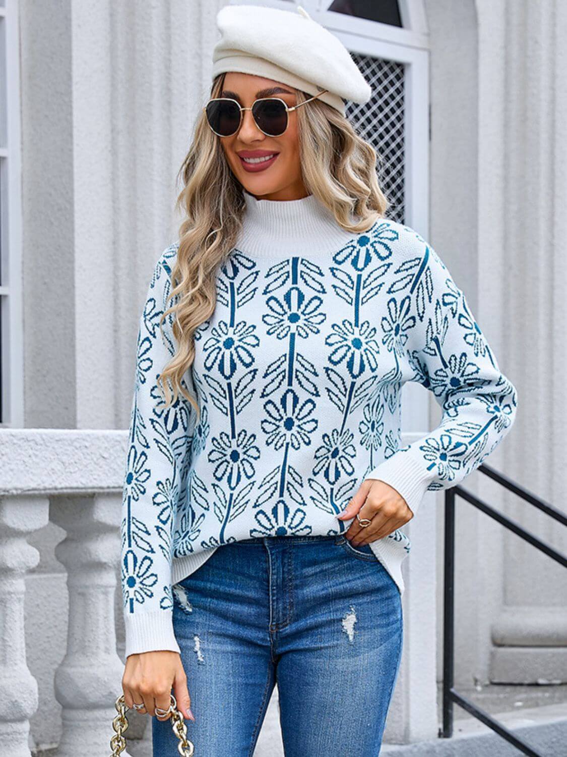 Stylish woman in Angel Wings Flower Turtleneck Sweater with floral pattern, jeans, and beret, exuding playful charm and elegance.