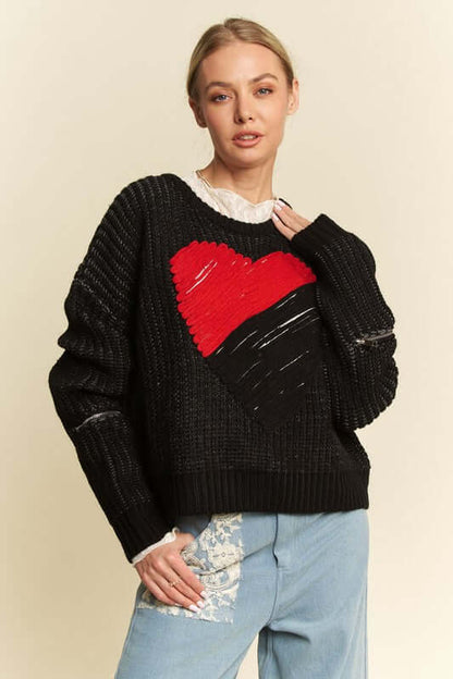 Trendy model wearing Davi & Dani Contrast Heart Dropped Shoulder Sweater with playful heart design and relaxed fit.