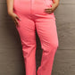 Woman wearing Kenya High Waist Side Twill Straight Jeans in bright coral, showcasing the flattering fit and elegant side twill detailing.