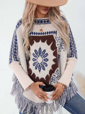 Stylish woman in Bella Road Fringe Geometric Poncho with coffee, featuring boho chic design and playful fringe details.