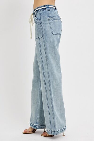 RISEN plus size straight leg jeans with pockets in light wash, showcasing a stylish and comfortable fit.