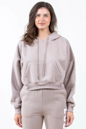 Trendy American Bazi 'Los Angeles' cropped hoodie in soft beige, featuring a drawstring detail and front pocket.