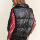 Woman wearing J.NNA snap and zipper shiny metallic puffer vest, styled with a sequin outfit for a chic look.