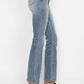 Side view of Judy Blue tummy control bootcut jeans with embroidered back pockets and trendy heels.