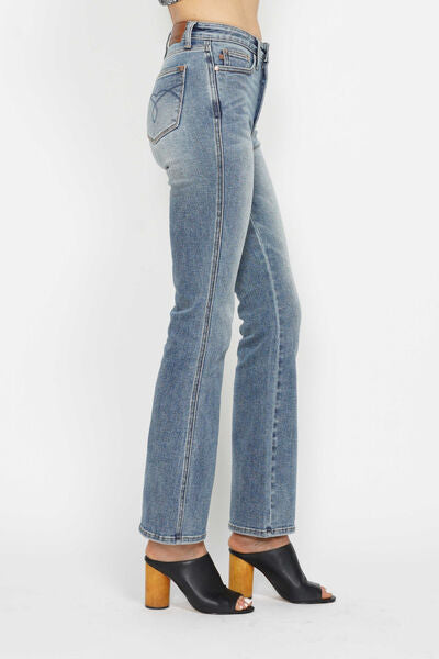 Side view of Judy Blue tummy control bootcut jeans with embroidered back pockets and trendy heels.