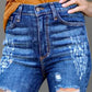 Woman wearing Raw Hem Distressed Bootcut Jeans with a trendy raw hem and stylish distressing detailing.