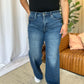 Woman wearing RFM Full Size High Rise Tummy Control Wide Leg Jeans in a casual indoor setting