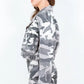 Side view of a plus-size cropped camouflage zip-up jacket, showcasing its trendy design and pocketed feature.