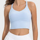 Light blue crisscross tank top, perfect for your active lifestyle, featuring a stylish round neck and moderate stretch.