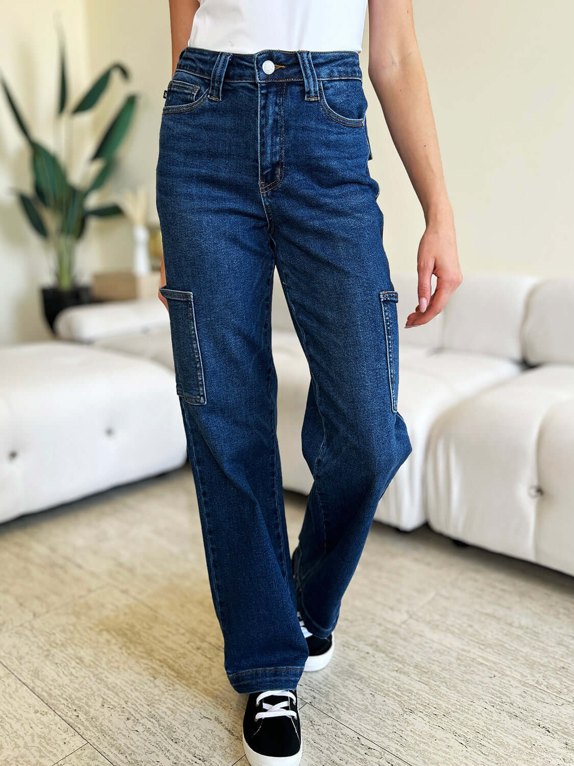 Woman wearing High Waist Straight Cargo Jeans with cargo pockets, featuring a flattering fit made from durable denim fabric by Judy Blue Jeans