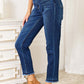 High Waist Released Hem Slit Jeans by Judy Blue in deep indigo wash, featuring a figure-flattering fit, styled with brown ankle boots.