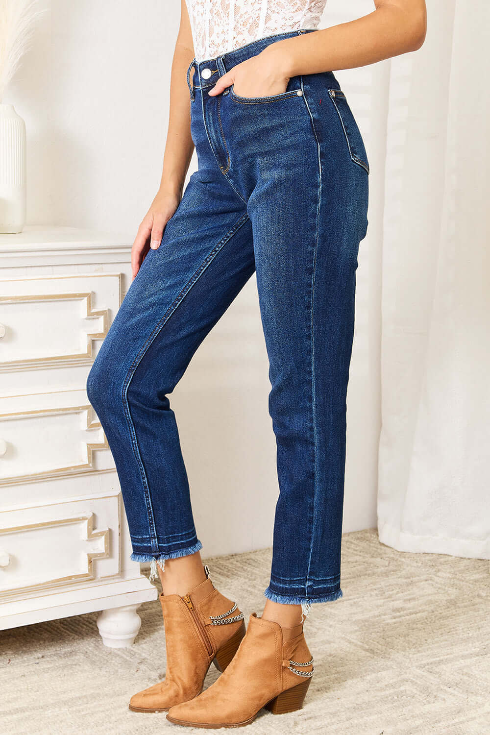 High Waist Released Hem Slit Jeans by Judy Blue in deep indigo wash, featuring a figure-flattering fit, styled with brown ankle boots.