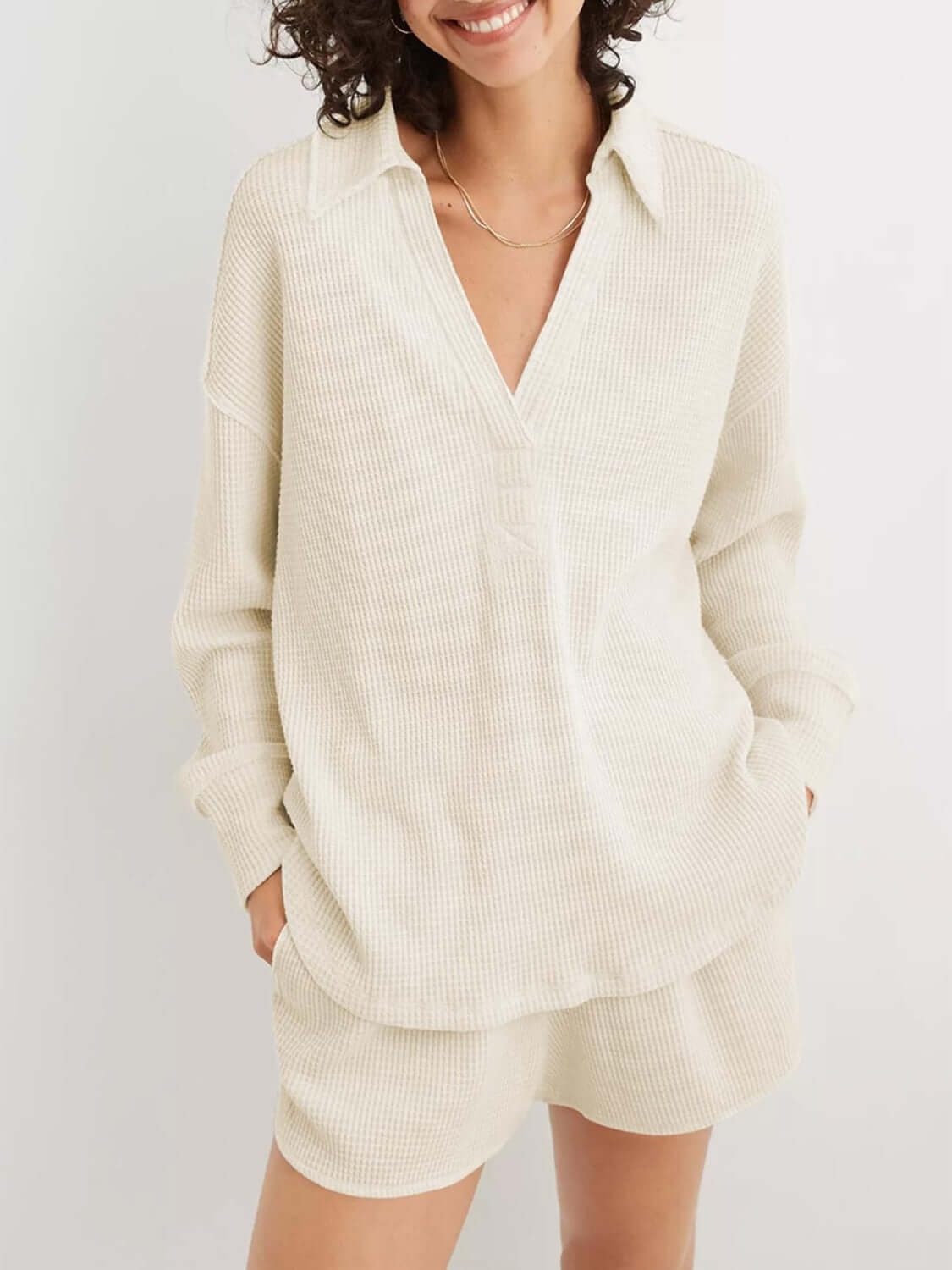 Woman wearing a Waffle-Knit Johnny Collar Long Sleeve Sweatshirt made of 65% cotton and 35% polyester, slightly stretchy and opaque.