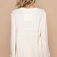 Back view of a cream long sleeve knit top with delicate texture and casual fit, perfect for layering and everyday wear.