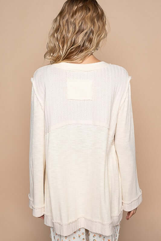 Back view of a cream long sleeve knit top with delicate texture and casual fit, perfect for layering and everyday wear.