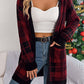 Woman wearing Bella Road Plaid Open Front Long Sleeve Cardigan in red, styled with jeans and a white top, standing by a Christmas tree.