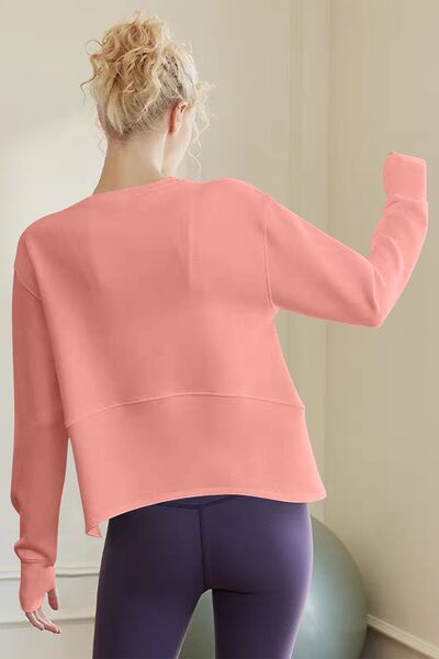 Back view of a woman in a sherbet-colored long sleeve sweatshirt, perfect for casual outings and lazy days.