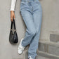 Stylish woman wearing Bella Road Asymmetric Waist Jeans with Pockets, showcasing comfort and fashion with plush lining.