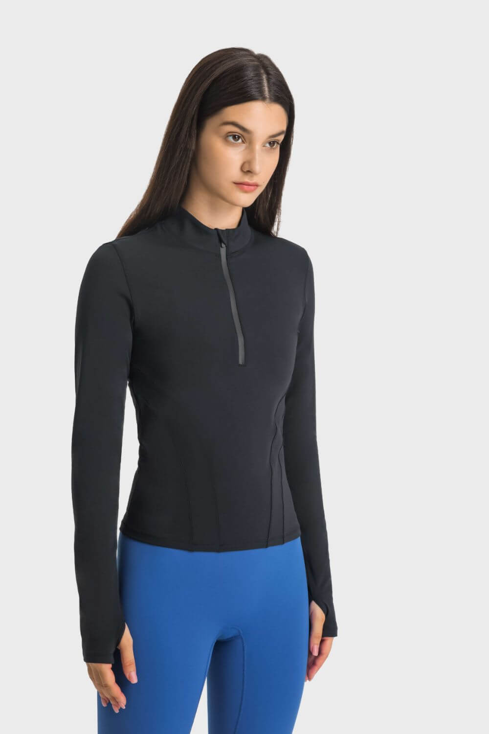 Model wearing Millennia Half Zip Thumbhole Sleeve Sports Top in black, perfect for yoga and workouts with stylish comfort.