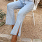 Light wash Bella Road side slit straight leg jeans with pockets, styled casually while sitting on a chair.