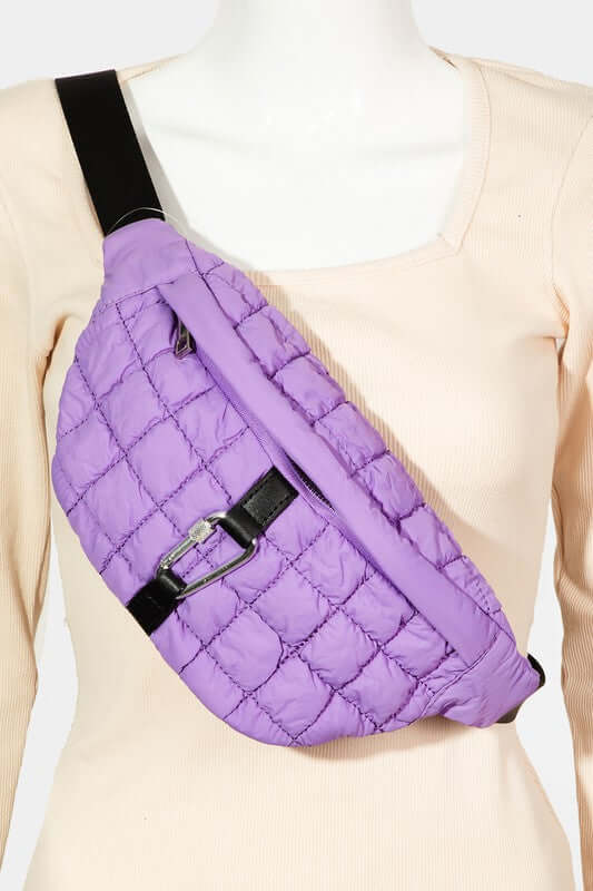 Stylish purple quilted sling bag with bubble texture and carabiner clip, perfect for carrying essentials while on the go.