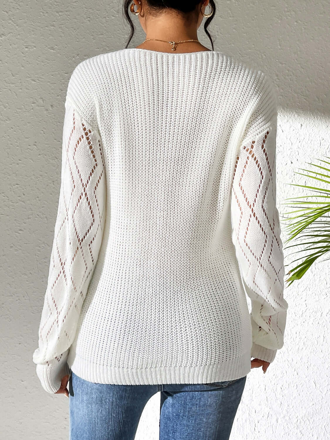 Stylish back view of Bella Road Openwork V-Neck Long Sleeve Sweater in white, featuring cozy batwing sleeves.