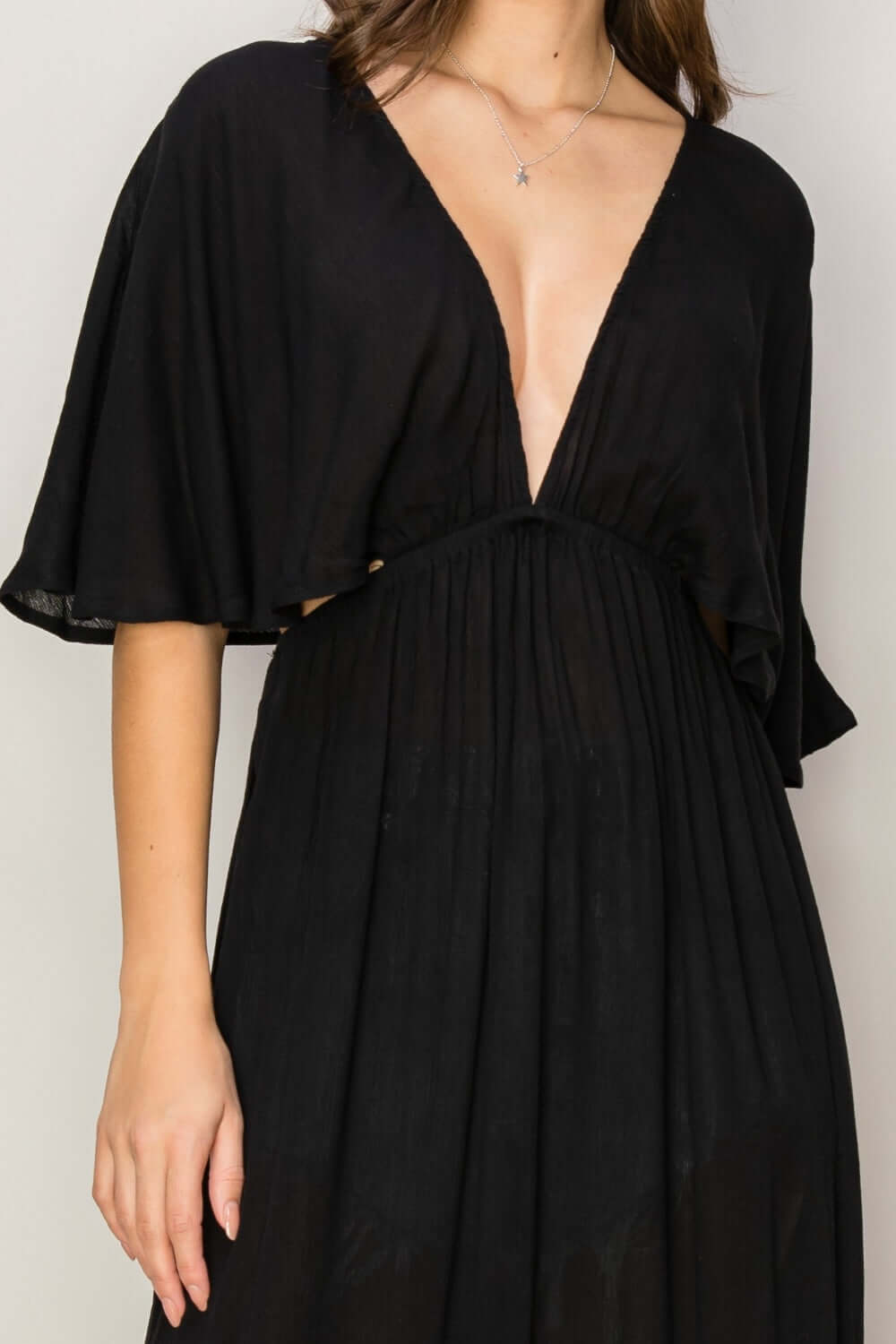 Black tie back maxi split cover-up dress with plunging neck, batwing sleeves, cinched waist, flowy skirt, and long side slits.