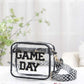 Transparent crossbody bag with "GAME DAY" letters, black glitter trim, and patterned strap, perfect for stadium security checks.